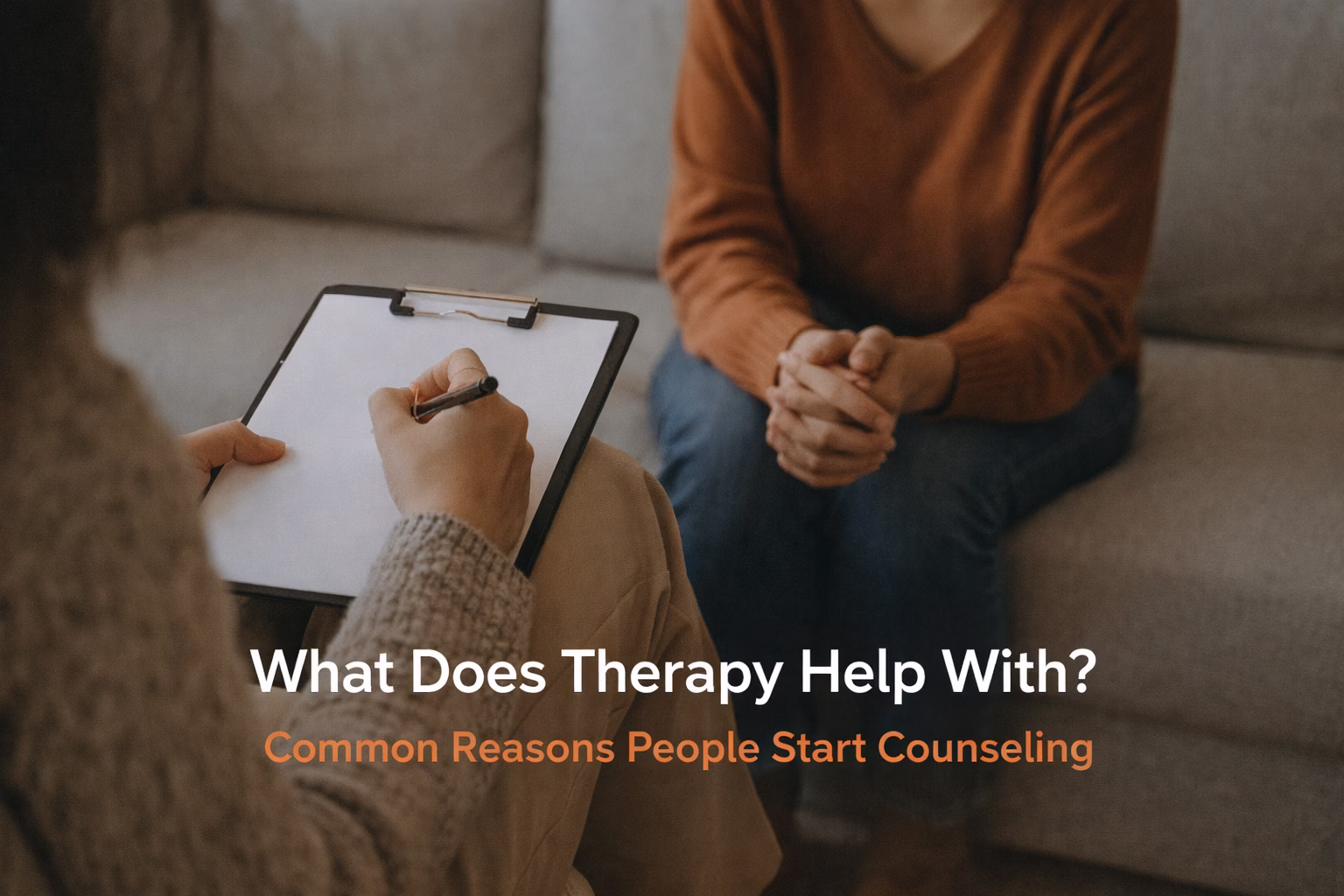 A therapist taking notes while meeting with a client in a calm counseling session, representing common reasons people begin therapy and how counseling provides support.